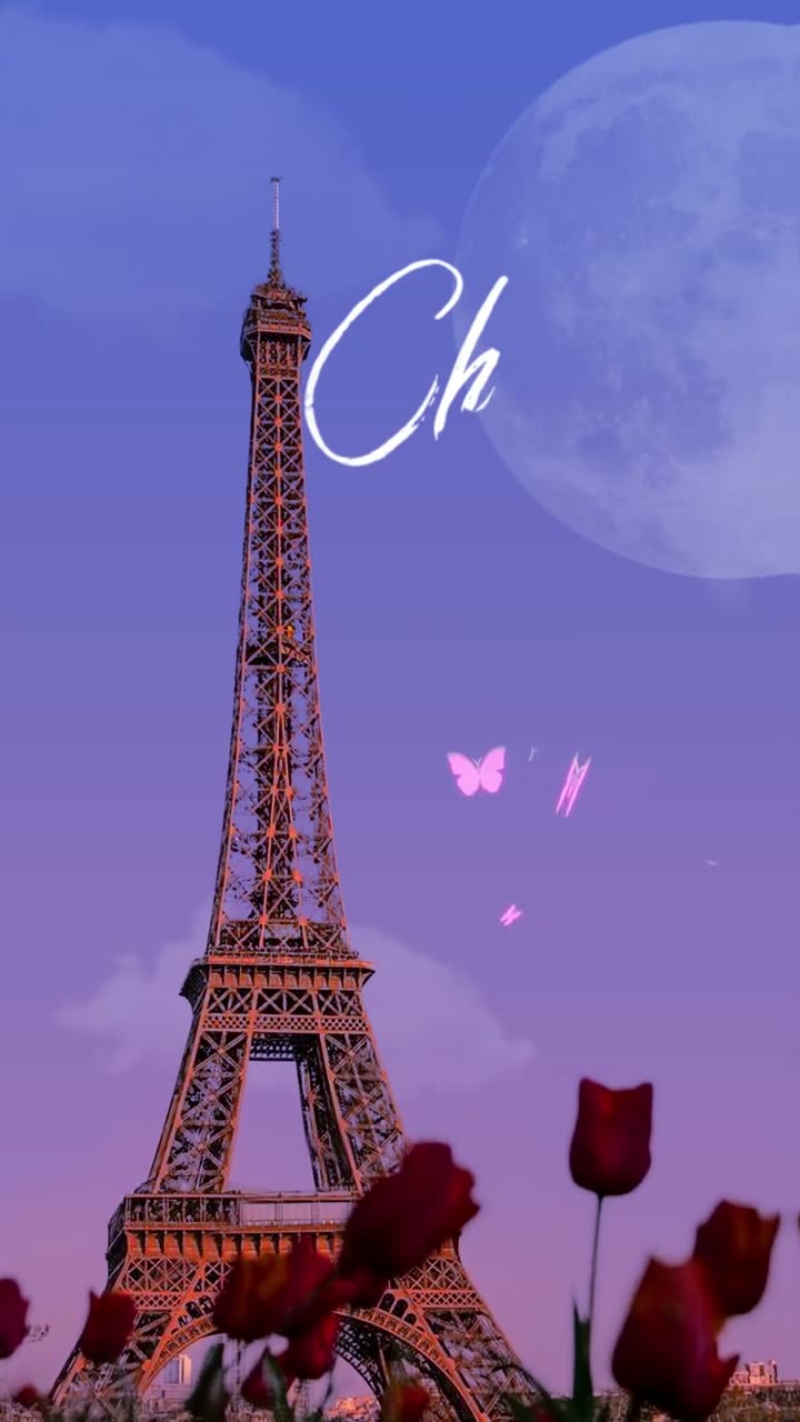 Chez Mila: the Eiffel Tower at dusk under a full moon with red tulips in the foreground.