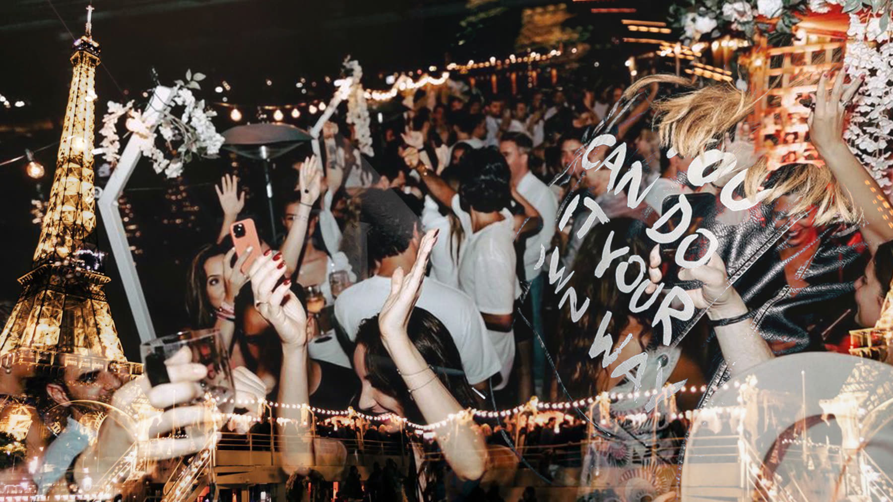 A crowd with hands up under the Eiffel Tower at night, strung lights overhead.